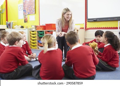 Elementary School Pupils Telling Story To Teacher