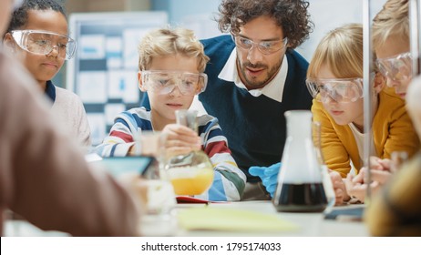 Elementary School Science Classroom: Enthusiastic Teacher Explains Chemistry to Diverse Group of Children, Little Boy Mixes Chemicals in Beakers. Children Acqaering Knowledge - Powered by Shutterstock