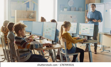 Elementary School Science Classroom: Teacher Educates Smart Little Schoolchildren who Work on Personal Computers, Learn Programming Language for Software Coding Schoolchildren Getting Modern Education