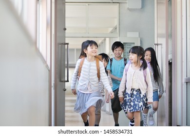 
Elementary School Student Carrying School Bags