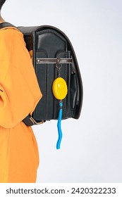 Elementary school student with security buzzer attached to school bag
