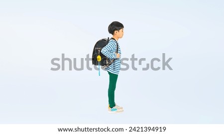Elementary school student with security buzzer attached to school bag