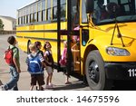 Elementary school students get on school bus
