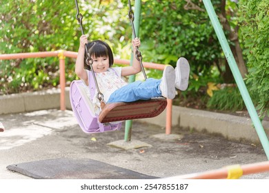 Elementary school students stop by the park after school to play on the swings