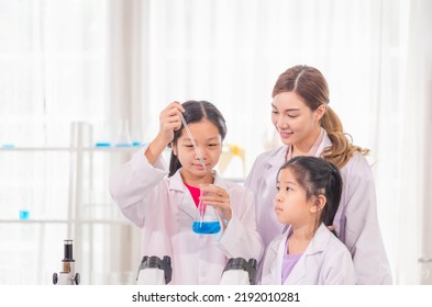 Elementary Science Class, Cheerful Kid Girl With Teacher Scientist In School Laboratory, Science Laboratory