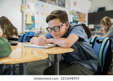 Elementary student studying at desk in classroom