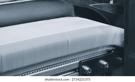 Elements of cardboard boxes are collected in stack. Conveyor line for the production of boxes. Machine cuts cardboard boxes from sheets of cardboard. Enterprise for  production package.