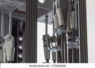Elements of fastening steel cables in the glass shaft of the elevator.