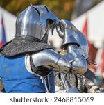 Elements of medieval iron knight armor for battle, helmet, spaulders, pouldrons, vambraces, gauntlets