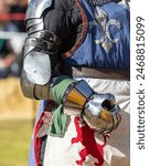 Elements of medieval iron knight armor for battle, helmet, spaulders, pouldrons, vambraces, gauntlets