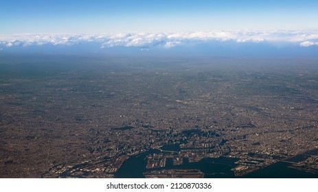 Elevate Landscape Of Houses And Roads At Fujinomiya City Near The Coast. Wonderful Top View From Airplane Window At Day Of Winter Season. Plane Flying Above Shore Ocean Japan Fuji Area.