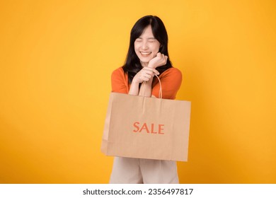 Elevate your shopping experience with love and the best deals. Smiling woman reveals purchases, capturing the thrill of discovering incredible savings. isolated on yellow background