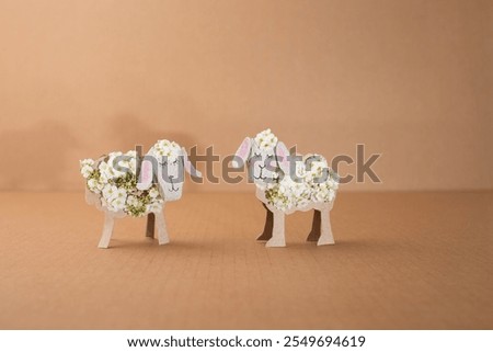 Elevate your spring decor with this unique folk art creation - a sheep ingeniously crafted from a toilet paper roll. Its floral embellishments add a burst of color and cheer.