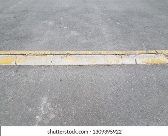 Elevated Asphalt Or Pavement Path With Yellow Curb Or Ramp