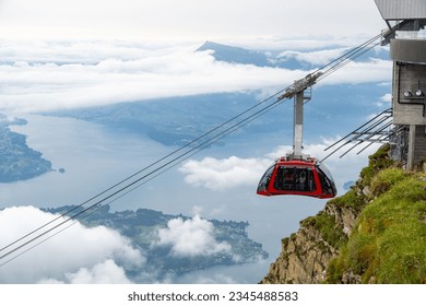 An elevated cable car at the top of a mountain above the clouds, Mount Pilatus, Switzerland - Powered by Shutterstock