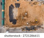 An elevated drone view captures the active early-stage construction of Highline Glenwood at the corner of West North Street and Glenwood Avenue in downtown Raleigh, North Carolina. The $200 million mixed-use project is set to become the city