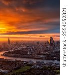 Elevated dusk view of the illuminated London city skyline after a colorful sunset, England, with copy space