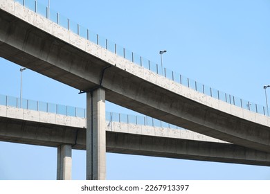 Elevated expressway during a sunny day .  highway overpass against blue sky .  Motorway viaduct interchange
