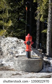 Elevated Fire Hydrant In A Protective Concrete Ring, Along A Mountain Road In A Winter Firefighting Concept