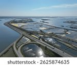 Elevated highway winds between salt flats and estuary waters near industrial zone in Aveiro, Portugal