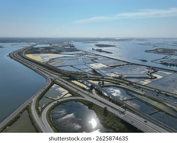 Elevated highway winds between salt flats and estuary waters near industrial zone in Aveiro, Portugal