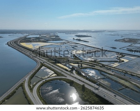 Elevated highway winds between salt flats and estuary waters near industrial zone in Aveiro, Portugal