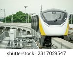 Elevated monorail train on rail. Public transit monorail. Modern mass transit. Electric vehicles. Rail transportation. Urban transport. Commuter train. Monorail technology. Rapid transit in the city.