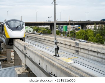 Elevated monorail train on rail. Public transit monorail. Modern mass transit. Rail transportation. Driverless straddle monorail on concrete guideway beam with conductor rail. Monorail technology.