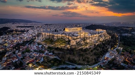 Elevated, panoramic view of the illuminated Acropolis of Athens, Greece, with the Parthenon Temple and the old town Plaka during dusk