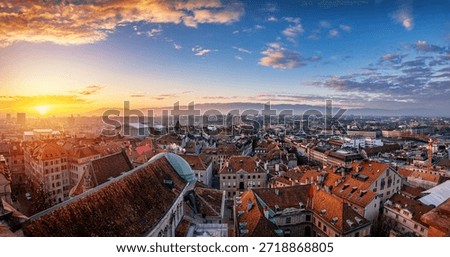 Elevated, Panoramic view of the rooftops at the skyline of Geneva, Switzerland, during a beautiful winter sunset