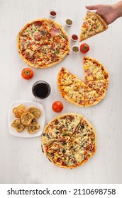 Elevated Perspective Of Table Served With Pizza, Garlic Bread, Oregano And Glass With Soda, Fast Food And Ready-to-eat Drink, Lifestyle Of Dinner Among Friends To Share, Studio