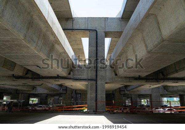 Elevated\
road or Highway interchange,Elevated expressway.Concrete structure\
of suspension bridge with sunlight,\
Thailand.
