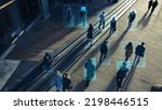 Elevated Security Camera Surveillance Footage of a Crowd of People Walking on Busy Urban City Streets. CCTV AI Facial Recognition Big Data Analysis Interface Scanning, Showing Personal Information.