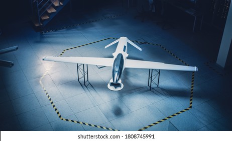 Elevated Shot Of An Unmanned Aerial Vehicle / Drone Prototype. Industrial Facility With Aircraft Capable Of GPS Surveillance And Military Missions