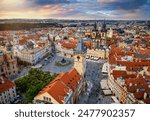 Elevated sunset view of the town square in the old city center of Prague, Czech Republic, with Tyn Church and Astronomical Clocktower