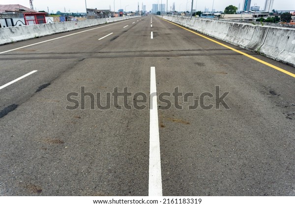 Elevated toll road with asphalt material and\
yellow line markings