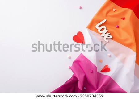 Elevated top view composition highlighting Lesbian Pride with a rippled flag, minuscule hearts, the word "love", all placed against a white background suitable for text or promotional use