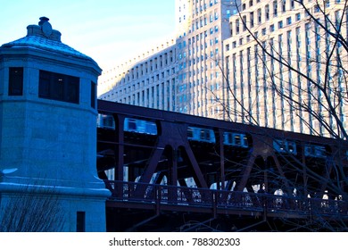 Elevated train in Chicago moving through the Loop over Chicago River on cold winter morning in January.