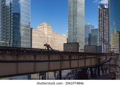 Elevated Train Tracks Crossing Through Downtown Chicago With Skyscrapers On A Sunny Day