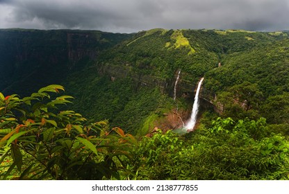 Elevated view across the Khasi hills with view of Nohkalikai waterfalls flanked by deep gorge with forested slopes under overcast sky near Shillong, Meghalaya, India. - Shutterstock ID 2138777855