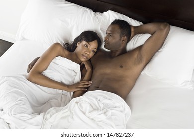 Elevated View Of An African American Couple Lying In Bed