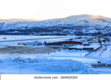 Elevated View Of An Airplane On The Tarmac Outside Terminal Buildings In Freezing Conditions At First Light, Alta Airport Within The Arctic Circle In Winter, Alta, Troms Og Finnmark,  Norway 03.04.20