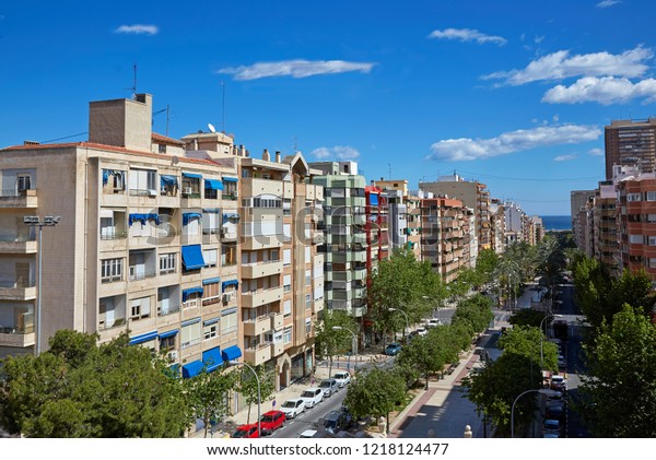 Elevated view of apartments and condos in Alicante\
under blue skies