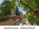 Elevated view of a beautiful street with a picturesque old-wooden steeple and a monastery in Plovdiv City, Bulgaria