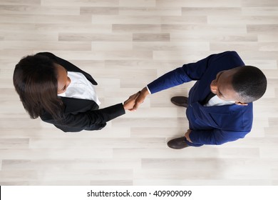 Elevated View Of Business Man And Woman Handshaking