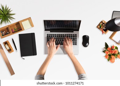 Elevated View Of A Businessperson's Hand Using Laptop With Blank Screen In Office