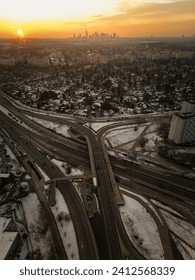An elevated view of a busy intersection, with multiple cars and cyclists passing through, Warsaw, Poland