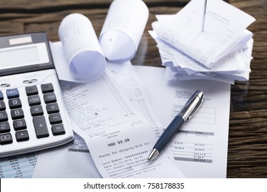 Elevated View Of Calculator And Pen On Receipt In Office