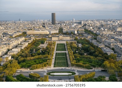 Elevated view from the Eiffel Tower overlooking Champ de Mars and École Militaire in Paris, France, surrounded by the dense Parisian cityscape.