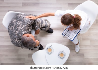 An Elevated View Of Female Councilor Consoling Soldier At Her Clinic - Powered by Shutterstock